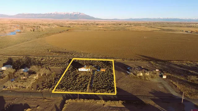 a bedroom with furniture and a large window