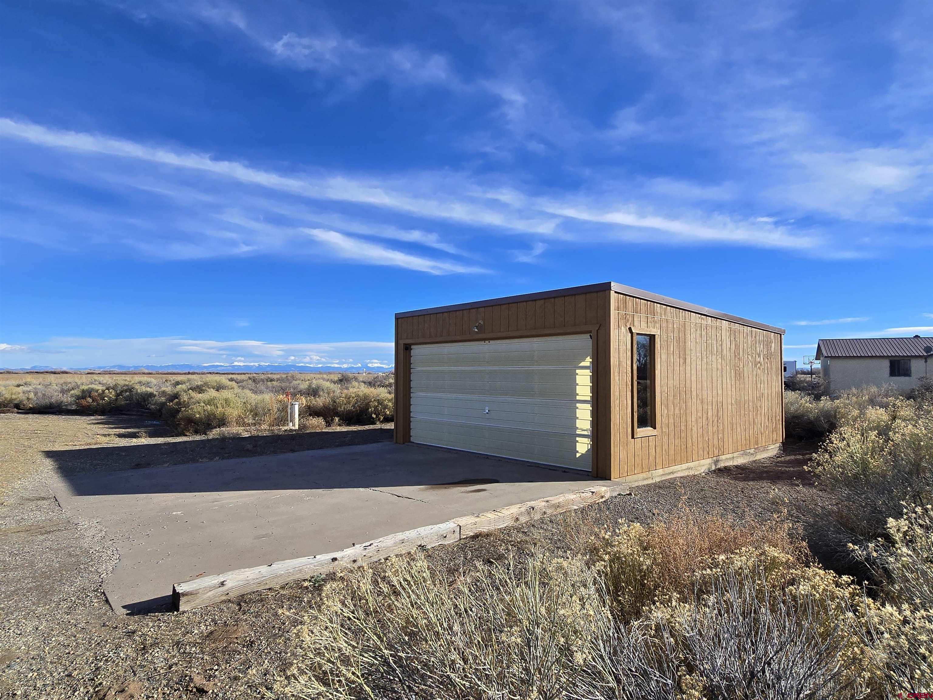 4590 Sierra Vista Road Alamosa, CO 81101 - Photo 24 of 31 a front view of a house with a yard