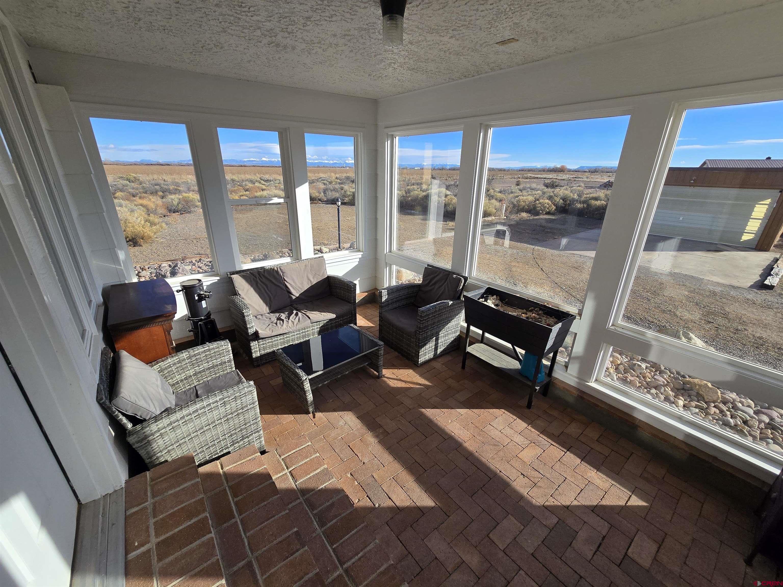 4590 Sierra Vista Road Alamosa, CO 81101 - Photo 4 of 31 a bedroom with furniture and a large window