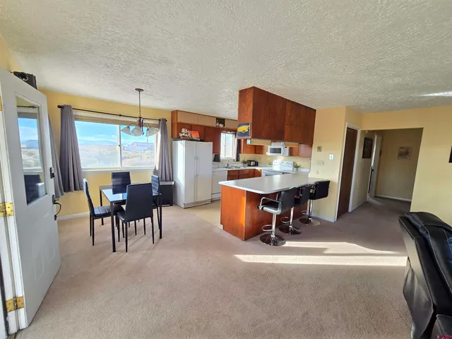 a kitchen with kitchen island granite countertop a sink stove and cabinets