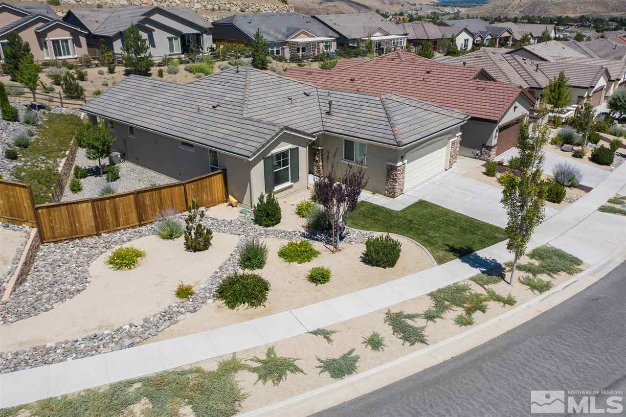an aerial view of a house with yard and patio