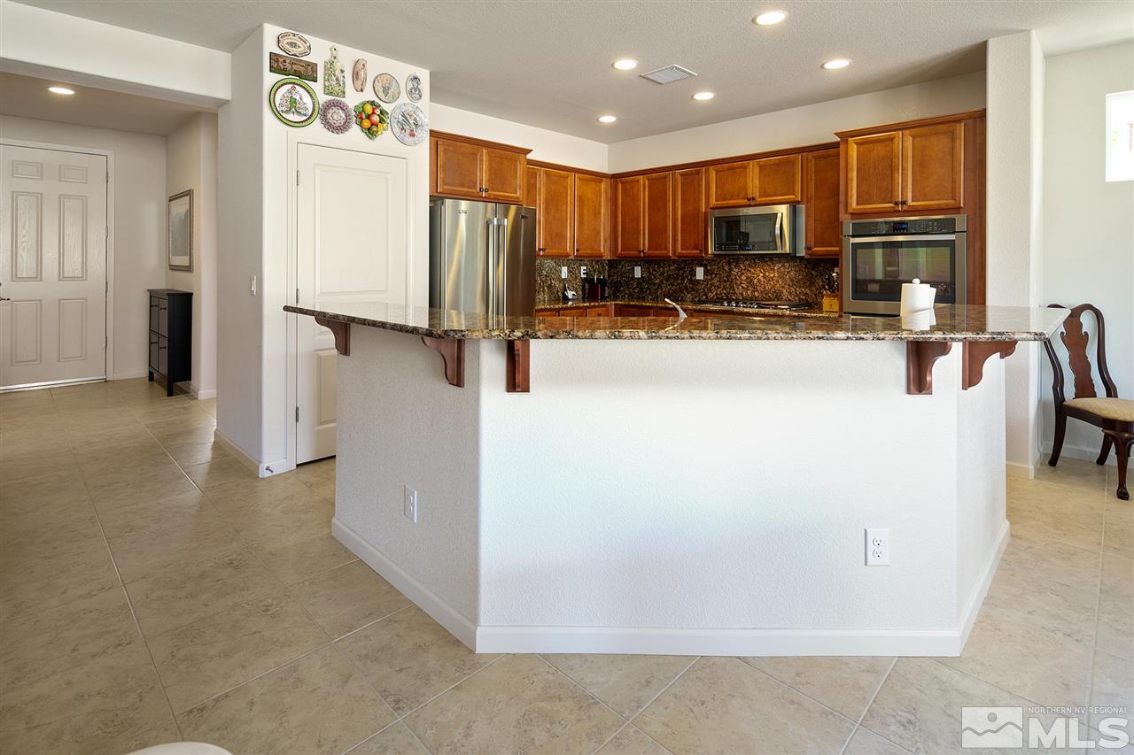 1420 Wakefield Trail Reno, NV 89523 - Photo 6 of 23 a view of kitchen with refrigerator stove microwave oven and kitchen island