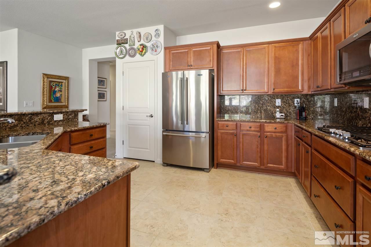 1420 Wakefield Trail Reno, NV 89523 - Photo 8 of 23 a kitchen with stainless steel appliances granite countertop a refrigerator a stove a sink and a microwave