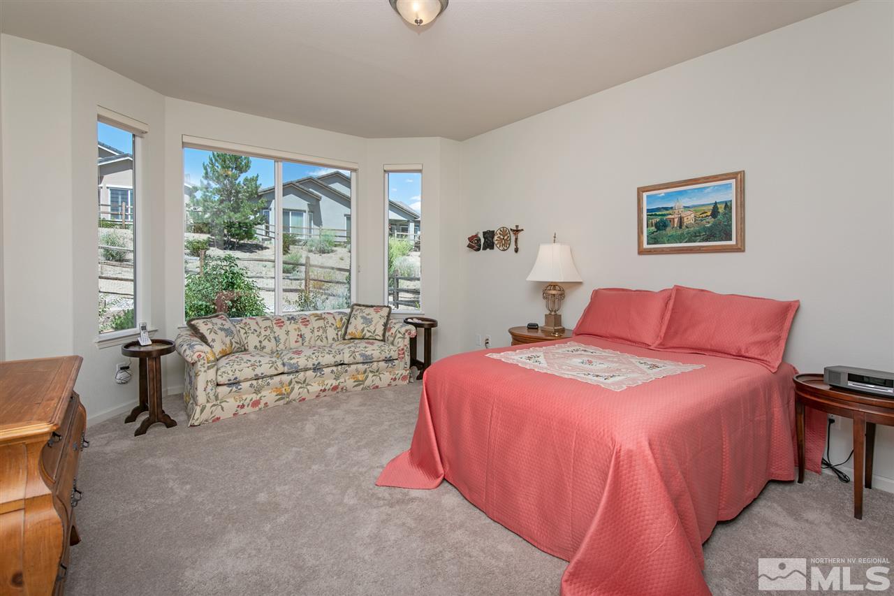 1420 Wakefield Trail Reno, NV 89523 - Photo 10 of 23 a spacious bedroom with a bed and a large window