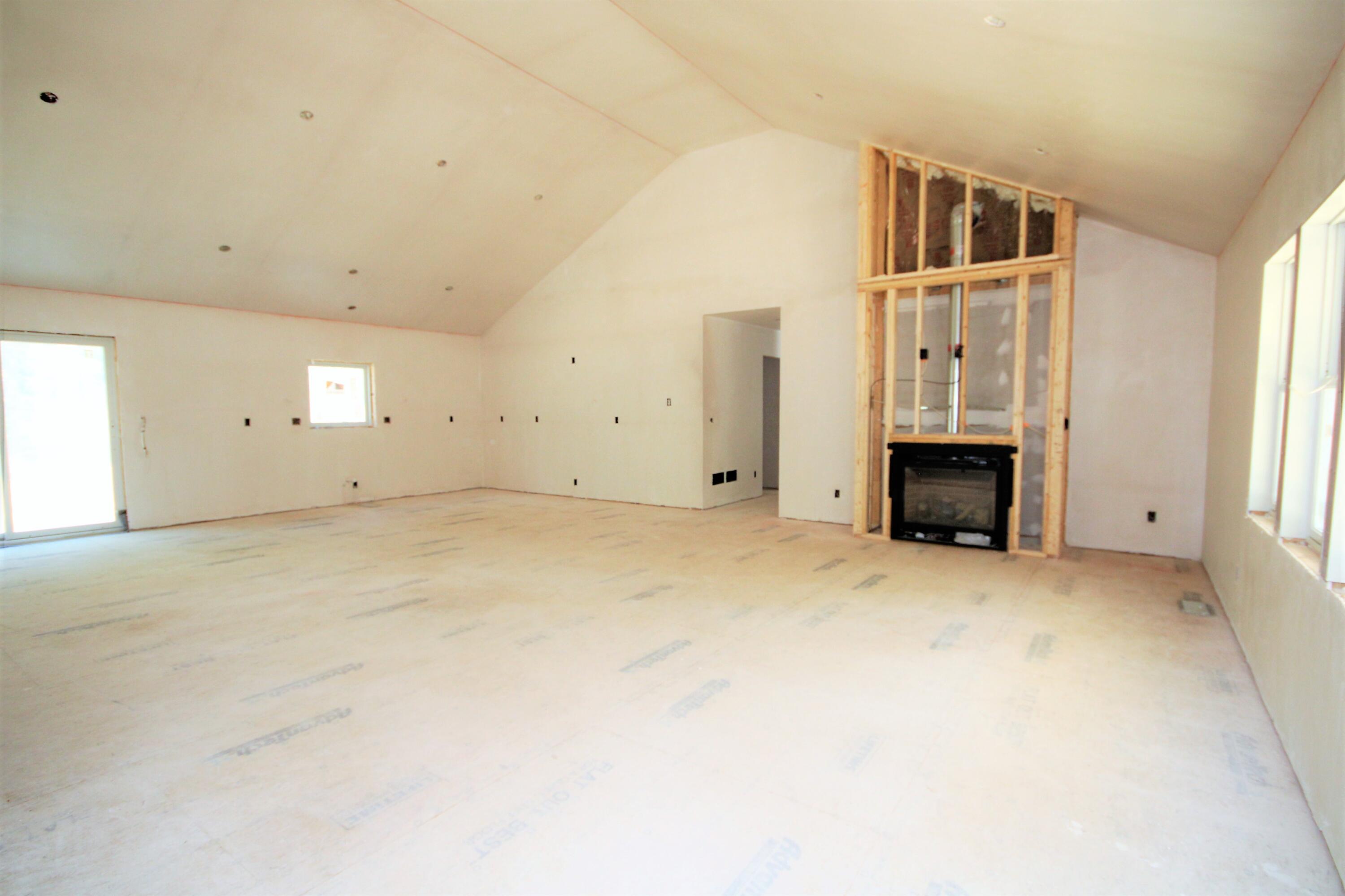 61 Lewis Neck Road East Falmouth, MA 02536 - Photo 9 of 37 an empty room with fireplace and windows