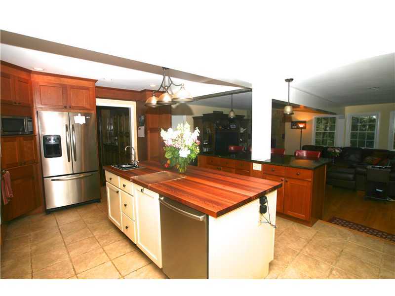 4 Florence Road Riverside, CT 06878 - Photo 8 of 25 a kitchen with stainless steel appliances granite countertop a sink and a refrigerator