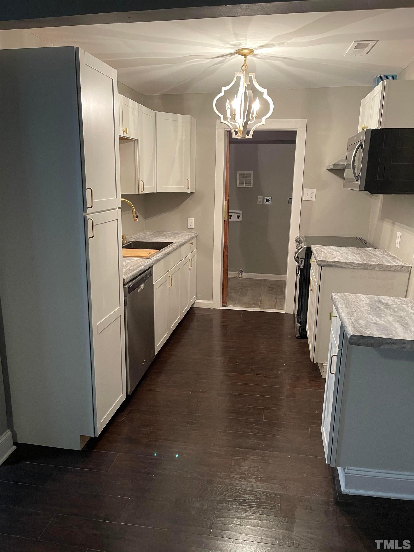 1401 Robinhood Road Durham, NC 27701 - Photo 2 of 14 a kitchen with a refrigerator and a sink