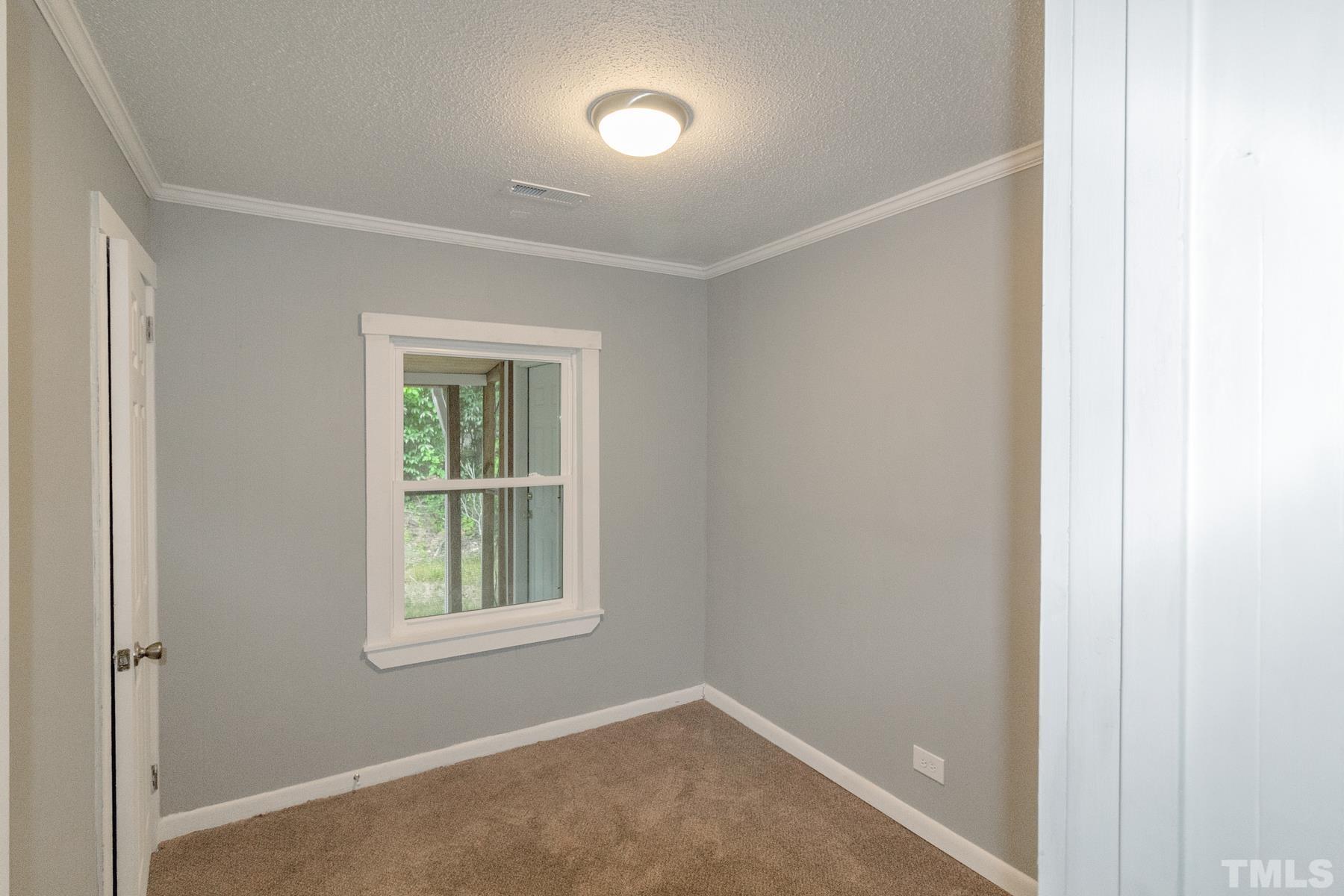 1401 Robinhood Road Durham, NC 27701 - Photo 9 of 14 a view of an empty room with a window