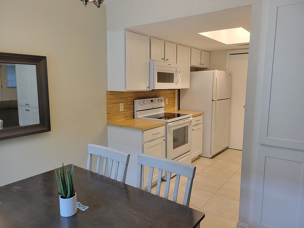 1401 Camp Craft Road, Unit C Austin, TX 78746 - Photo 9 of 12 A well-appointed cooking area features ample cabinetry and integrated appliances.