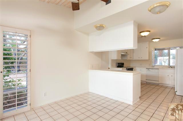 70415 Cobb Road Rancho Mirage, CA 92270 - Photo 8 of 23 a kitchen with cabinets and white appliances