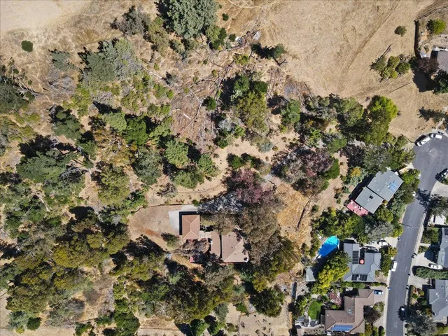 an aerial view of a house with a yard