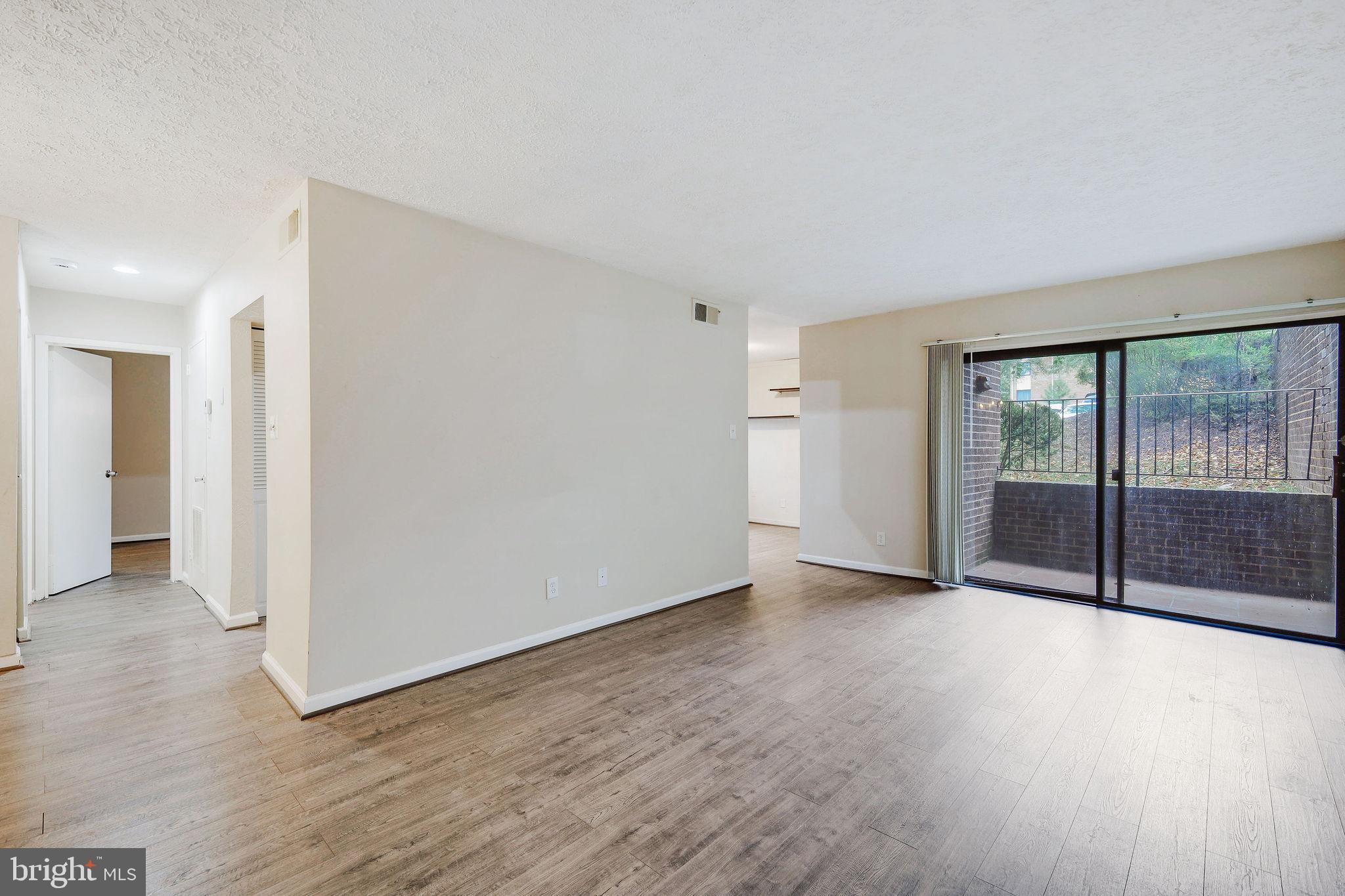 a view of an empty room with glass door