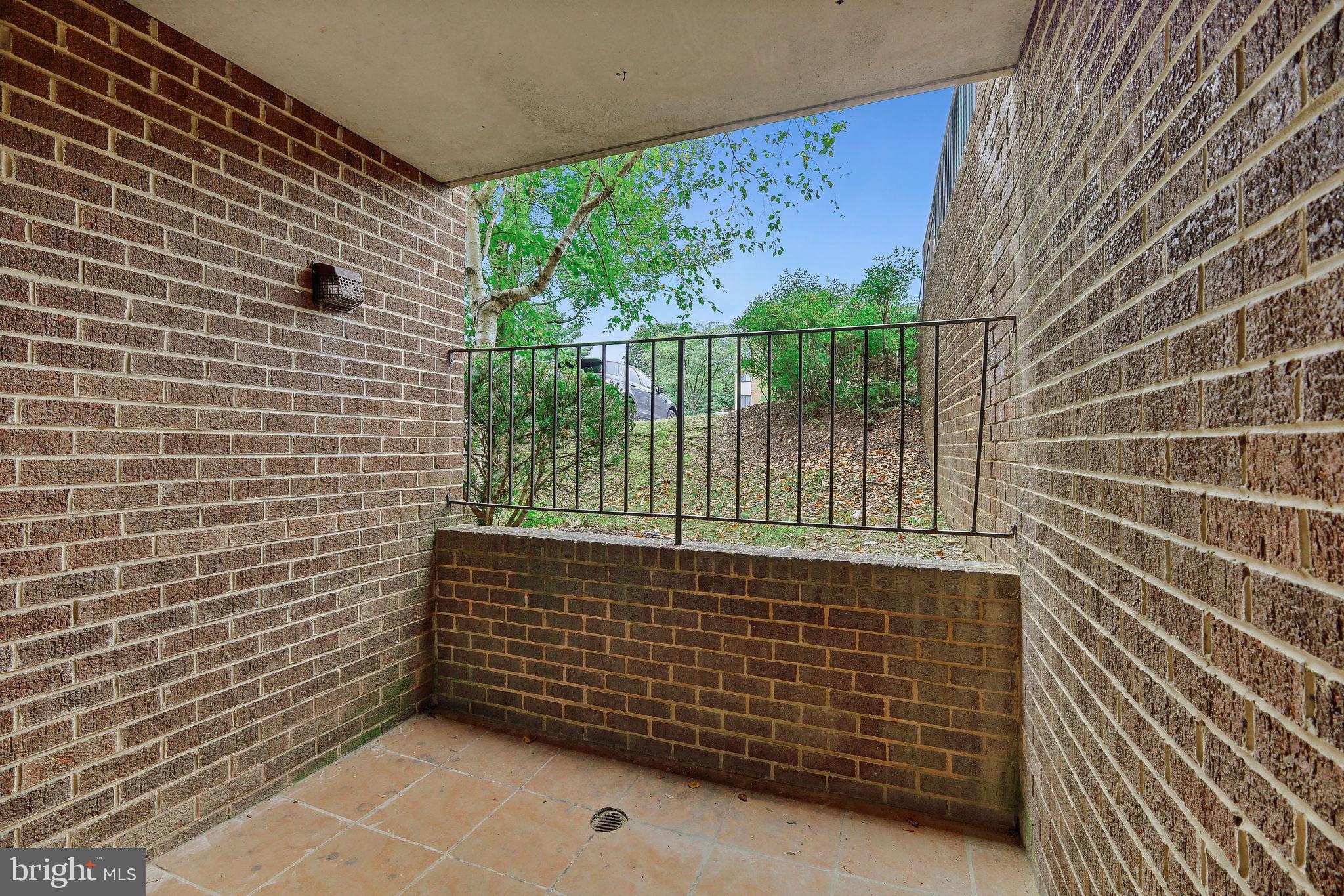 11240 Cherry Hill Road, Unit 18 Beltsville, MD 20705 - Photo 11 of 28 a view of a brick wall with a window