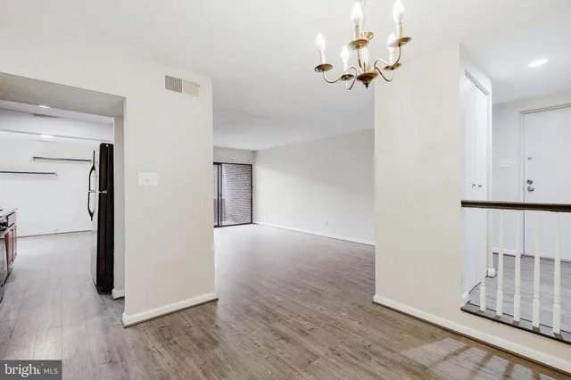 a view of a room with wooden floor
