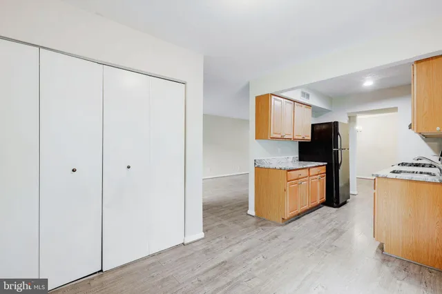 a kitchen with stainless steel appliances granite countertop a refrigerator and a stove top oven