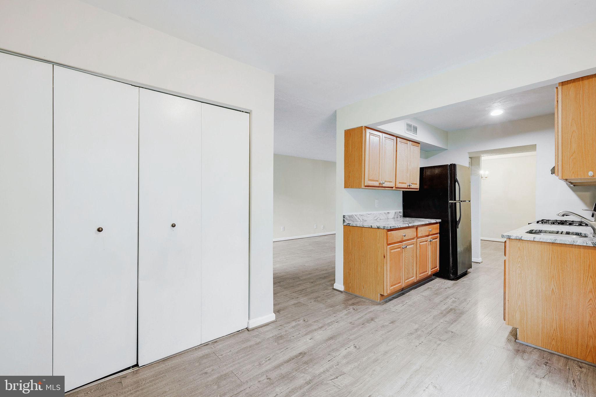 11240 Cherry Hill Road, Unit 18 Beltsville, MD 20705 - Photo 18 of 28 a kitchen with stainless steel appliances granite countertop a refrigerator and a stove top oven