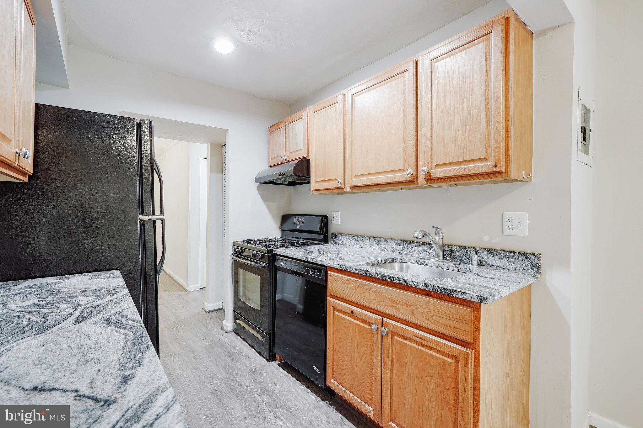 11240 Cherry Hill Road, Unit 18 Beltsville, MD 20705 - Photo 2 of 28 a kitchen with stainless steel appliances granite countertop a stove a sink and a refrigerator