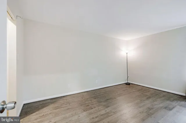 an empty room with wooden floor