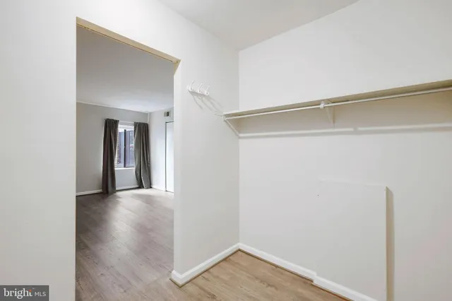 a view of a room with wooden floor
