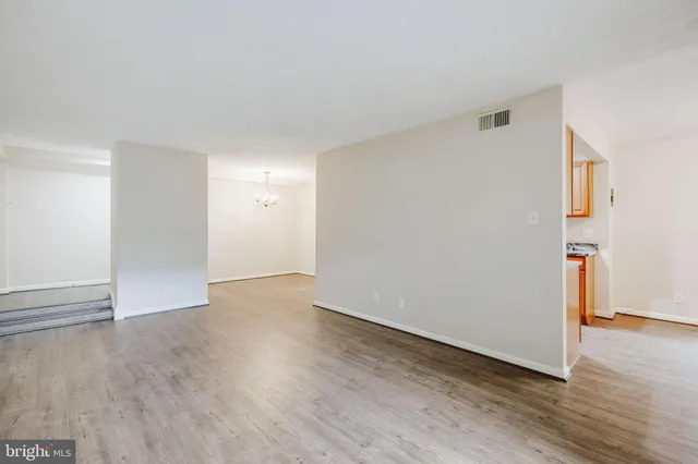 a view of a room with wooden floor