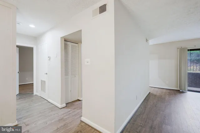 a view of hallway with wooden floor