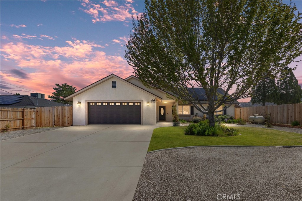 a front view of house with yard and trees