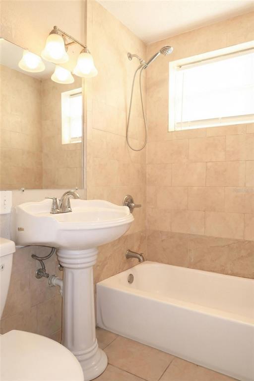 1105 West Nassau Street Tampa, FL 33607 - Photo 16 of 22 a bathroom with a sink a mirror and a bathtub