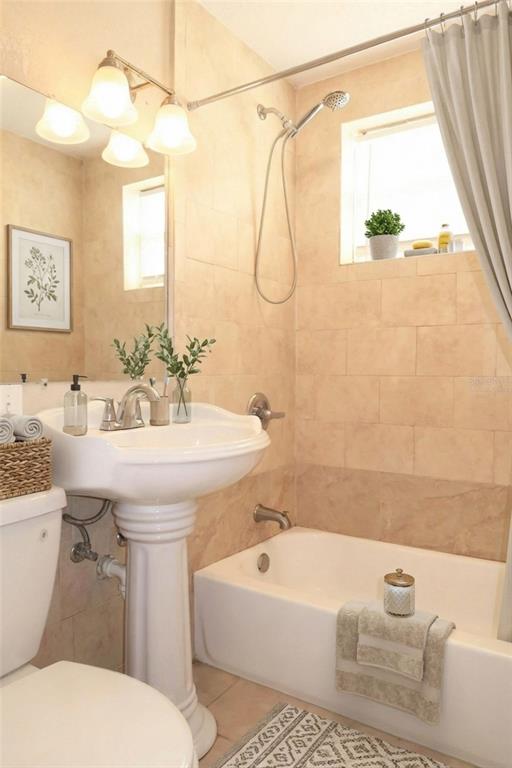 1105 West Nassau Street Tampa, FL 33607 - Photo 9 of 22 a bathroom with a sink a mirror and a toilet