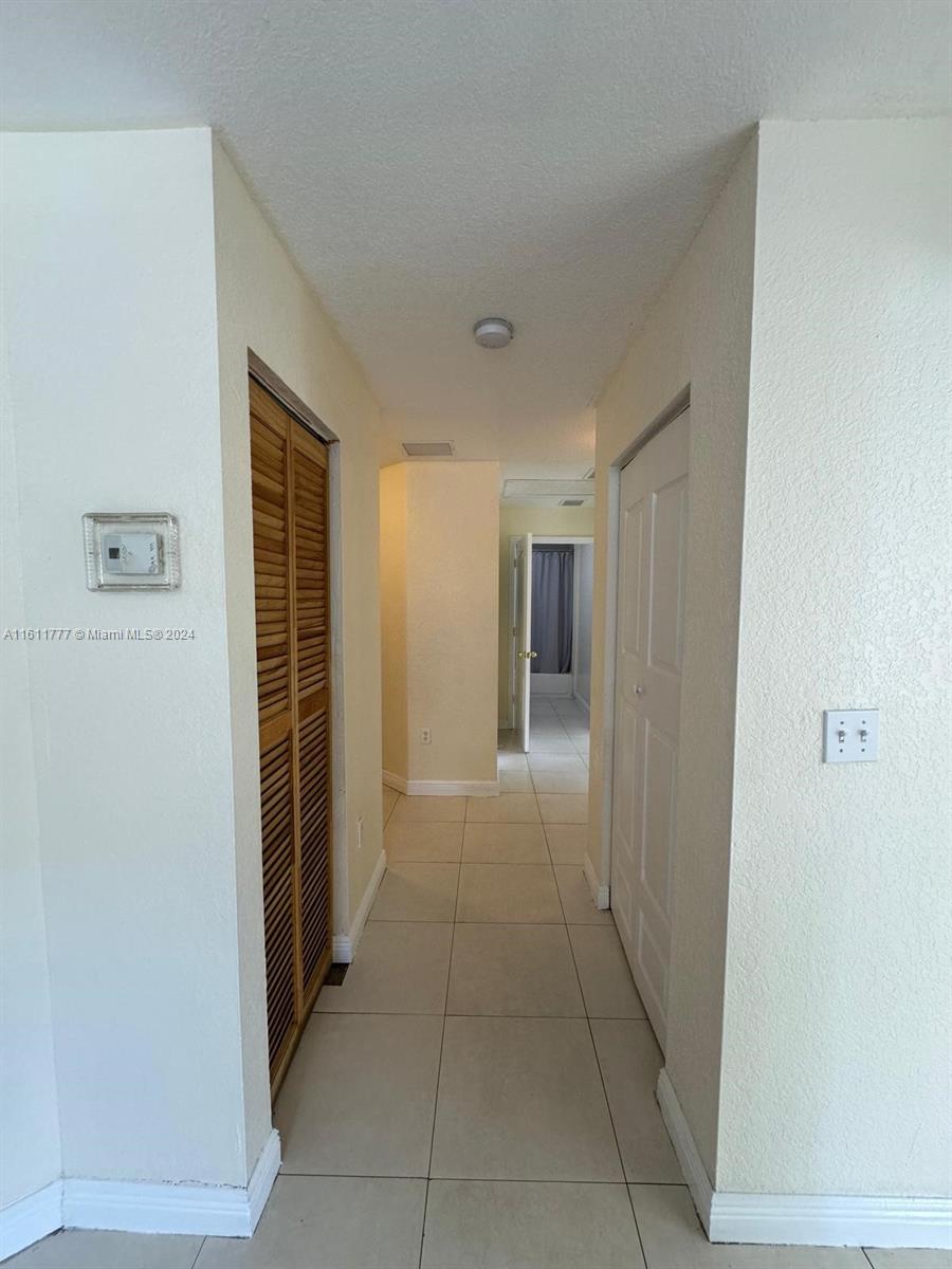 6920 Northwest 4th Avenue, Unit FRONT Miami, FL 33150 - Photo 4 of 13 a view of hallway with walk in closet and window