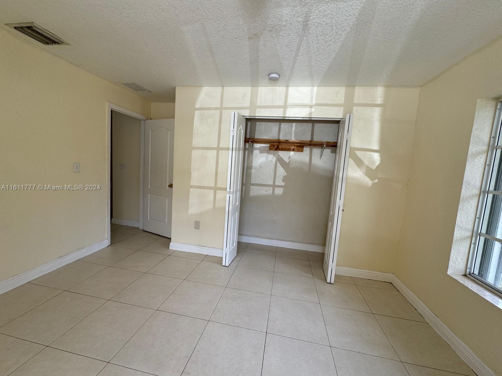6920 Northwest 4th Avenue, Unit FRONT Miami, FL 33150 - Photo 6 of 13 a view of an empty room with a kitchen