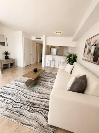 a large bed sitting in a bedroom and living room