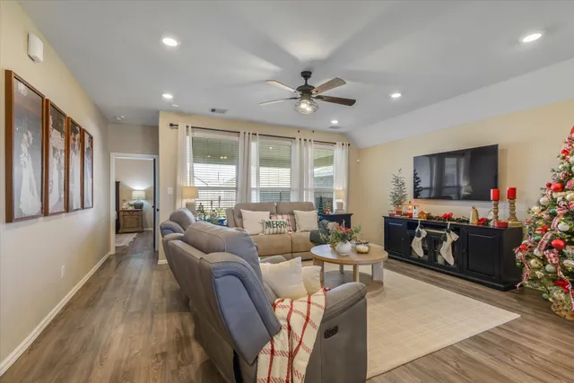a living room with furniture and a flat screen tv