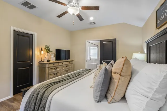 a bedroom with a bed and a flat screen tv