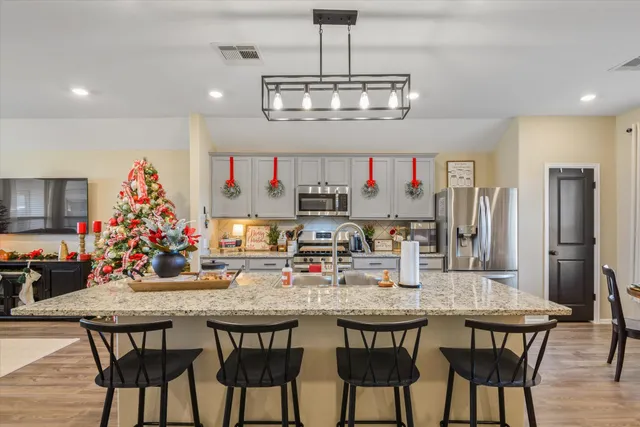a view of a dining room with furniture a chandelier and wooden floor