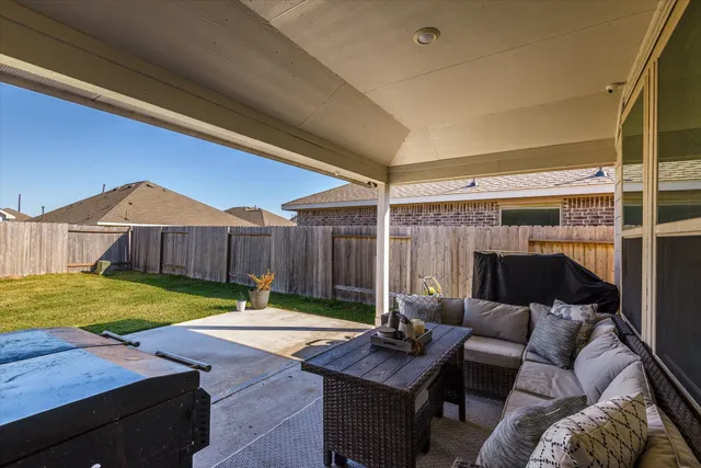 a backyard of a house with yard table and chairs