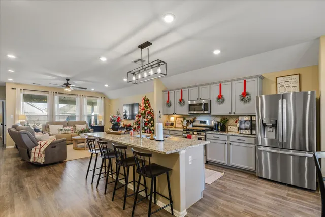 a kitchen with kitchen island granite countertop lots of counter top space and stainless steel appliances