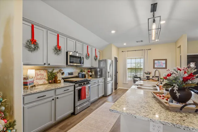 a kitchen with sink cabinets and stainless steel appliances