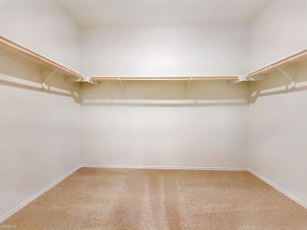 419 Sickle Loop Kyle, TX 78640 - Photo 21 of 35 Ample closet space with practical shelving and clothing rods offers versatile storage solutions.