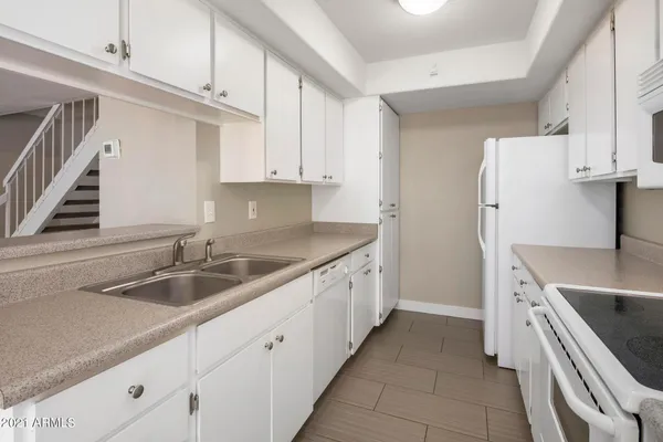 a kitchen that has a sink and a stove