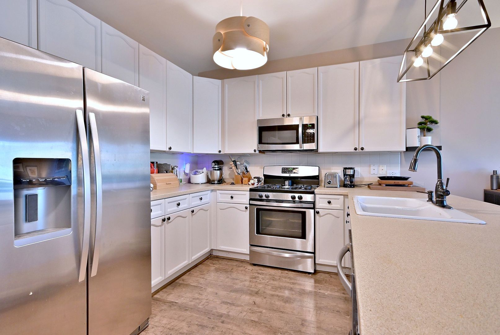 145 South York Street, Unit 404 Elmhurst, IL 60126 - Photo 12 of 28 a kitchen with stainless steel appliances granite countertop a refrigerator a stove a sink and a microwave