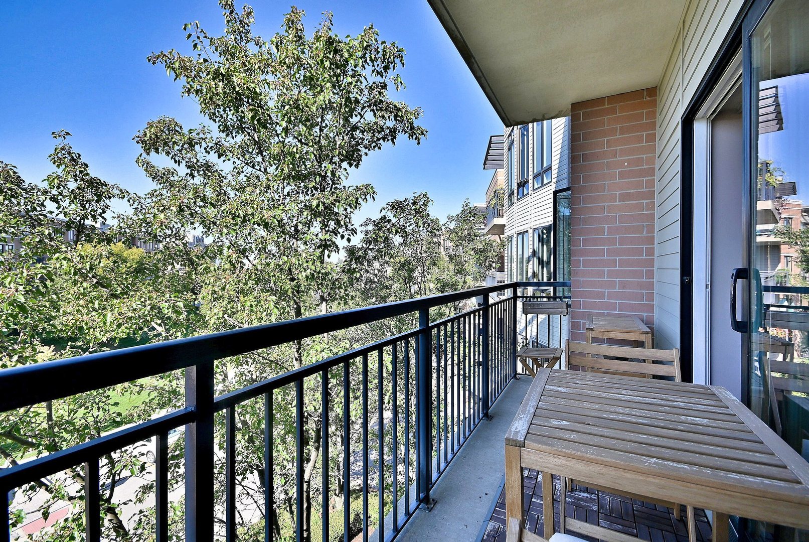 145 South York Street, Unit 404 Elmhurst, IL 60126 - Photo 9 of 28 a view of a balcony with wooden chairs
