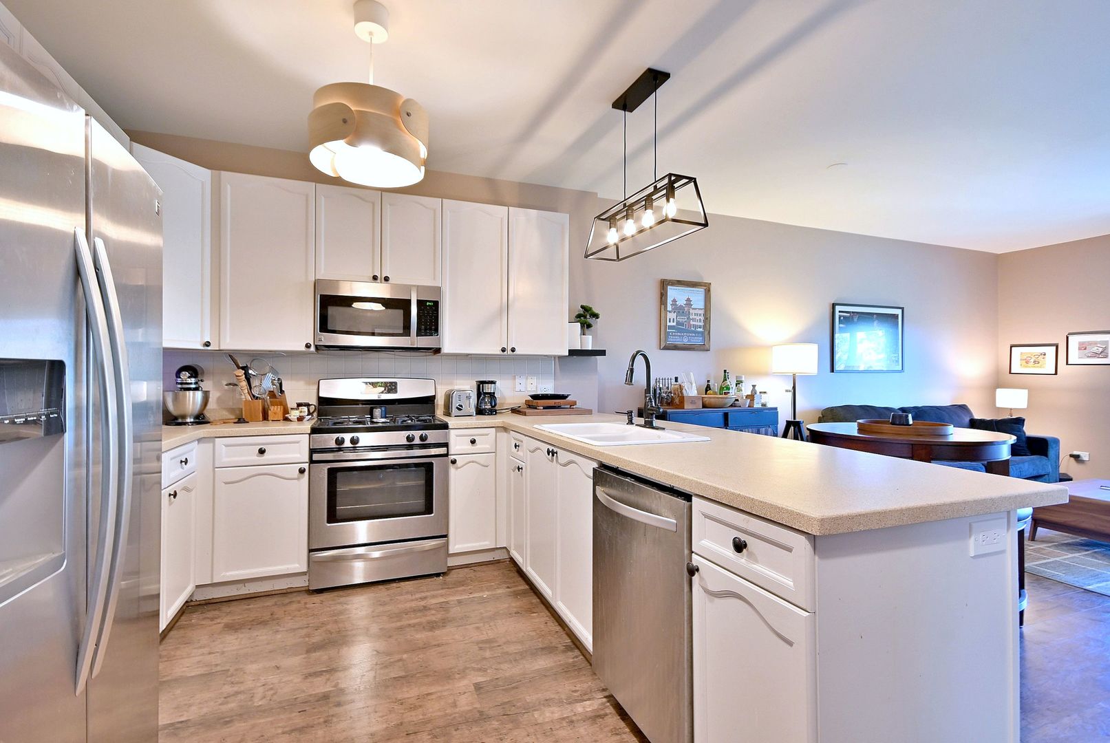 145 South York Street, Unit 404 Elmhurst, IL 60126 - Photo 10 of 28 a kitchen with white cabinets and stainless steel appliances