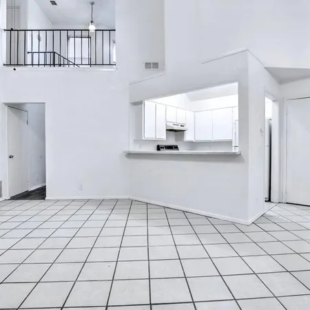 a view of a kitchen with wooden cabinet