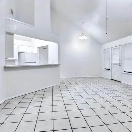 a kitchen with granite countertop a stove top oven and cabinets