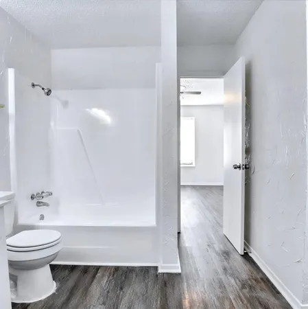 a view of a room with wooden floor