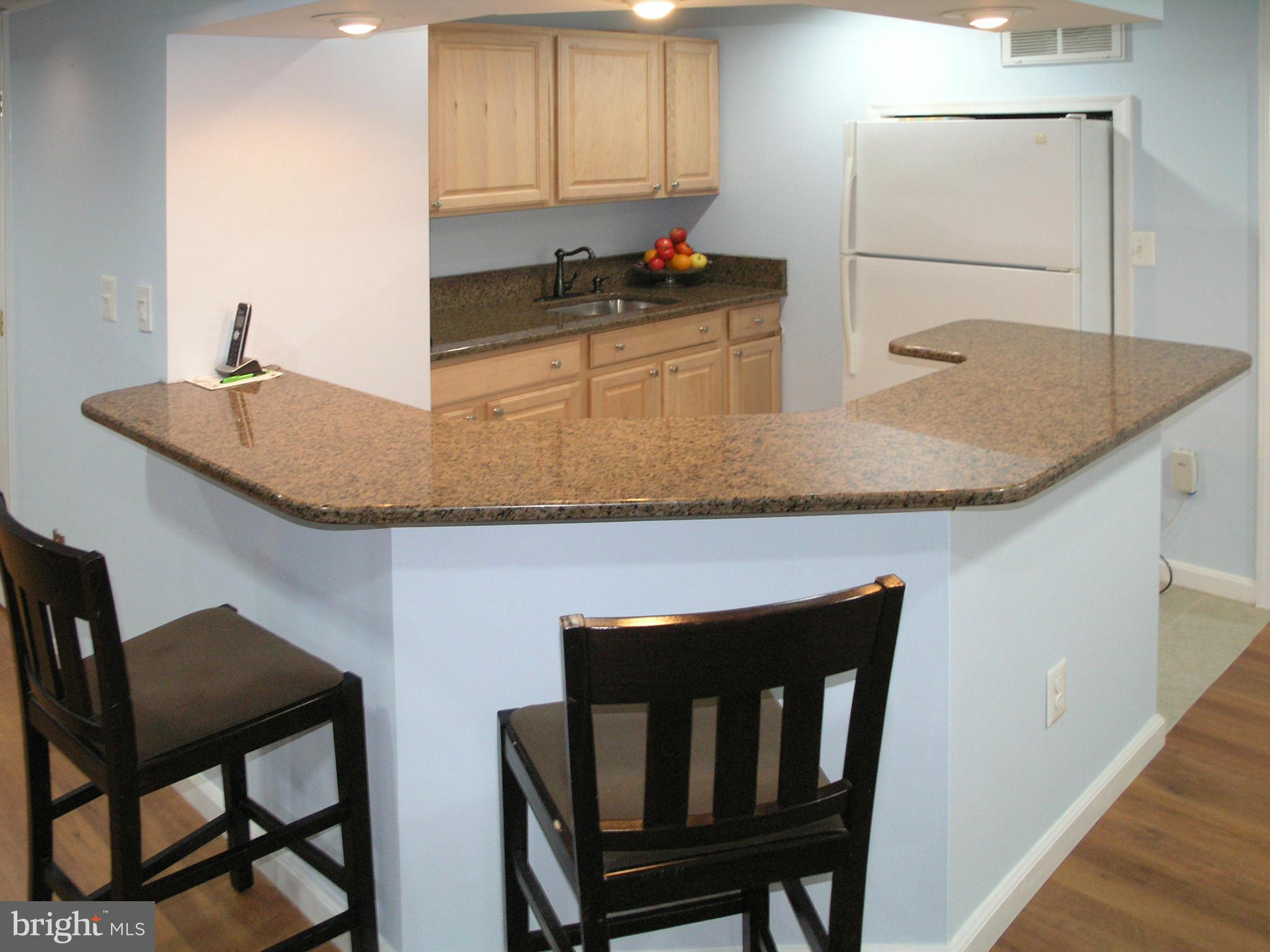 47611 Rhyolite Place Sterling, VA 20165 - Photo 19 of 29 a kitchen with a table chairs and a refrigerator