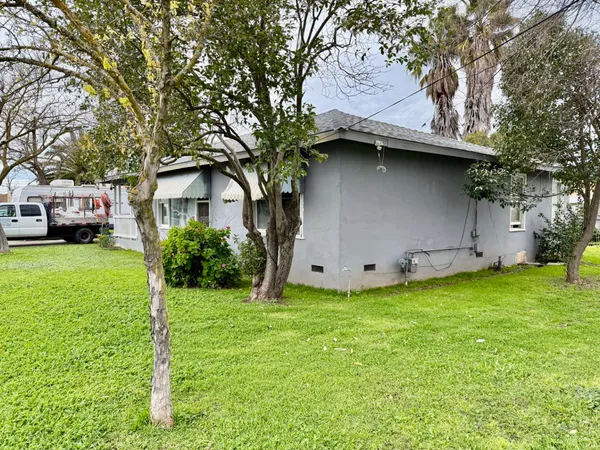 a view of a house with a yard and a garden