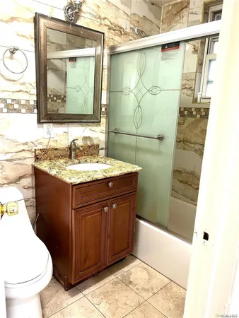 a bathroom with a sink a toilet and mirror