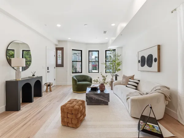 a living room with furniture a fireplace and a potted plant