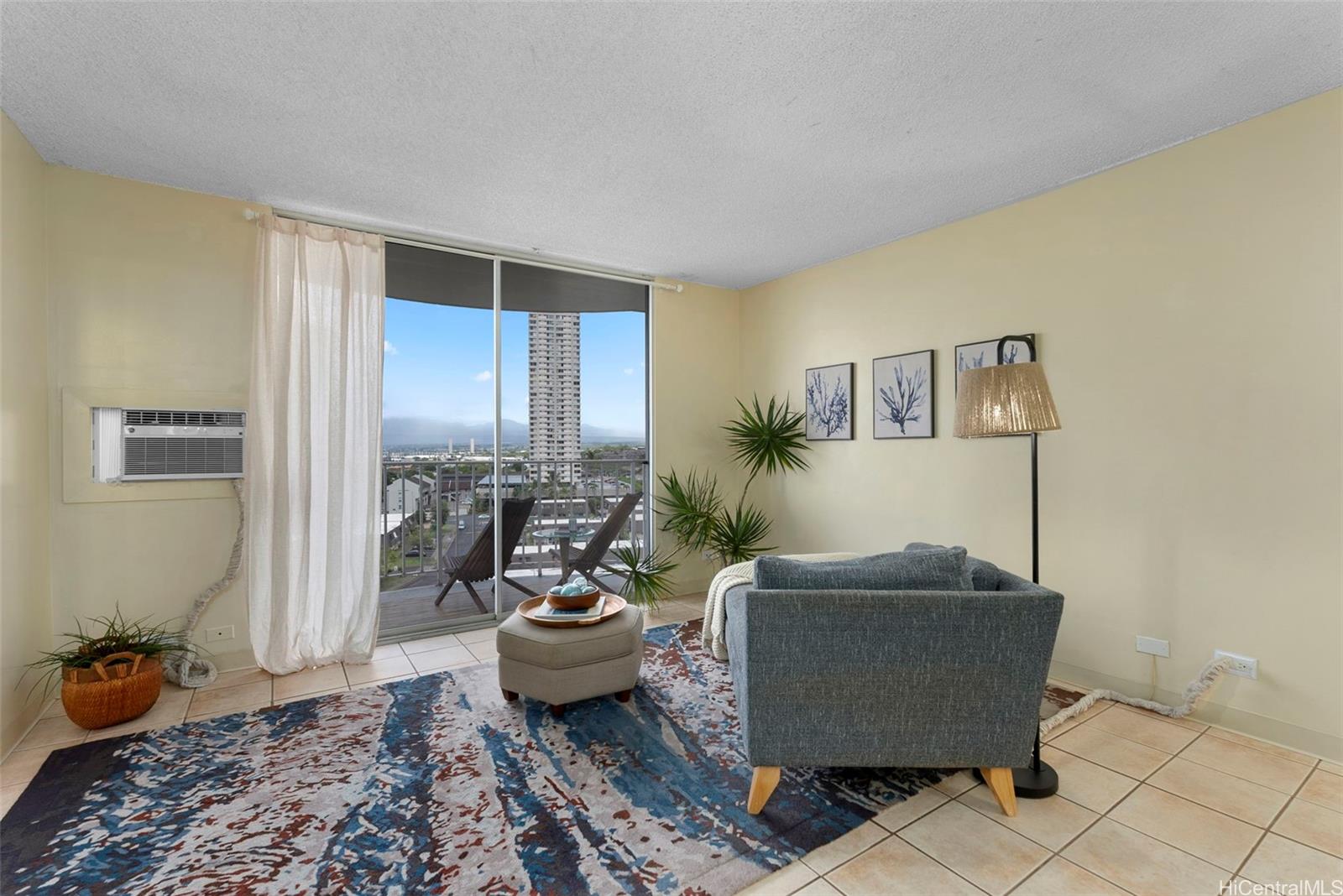 98-1038 Moanalua Road, Unit 1502 Aiea, HI 96701 - Photo 12 of 20 a living room with furniture and a potted plant